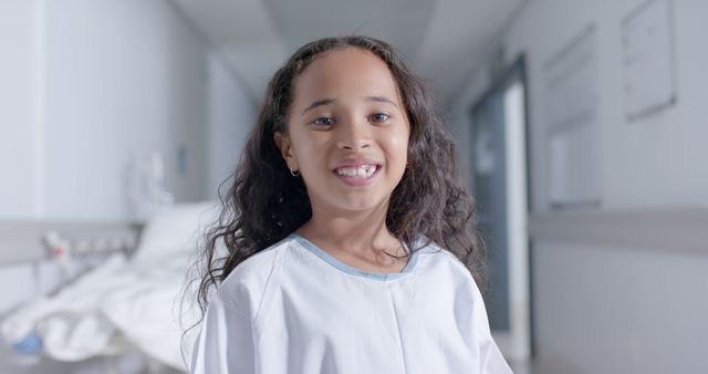 Smiling Girl in Hospital Corridor Wearing Patient Gown - Download Free Stock Images Pikwizard.com