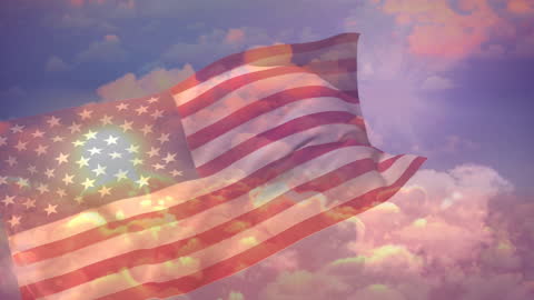 American Flag Waving Against Cloudy Sky