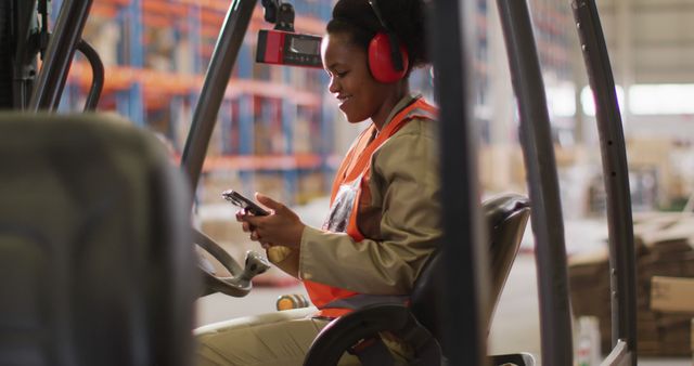 Female Warehouse Worker Operating Forklift and Using Phone - Download Free Stock Images Pikwizard.com