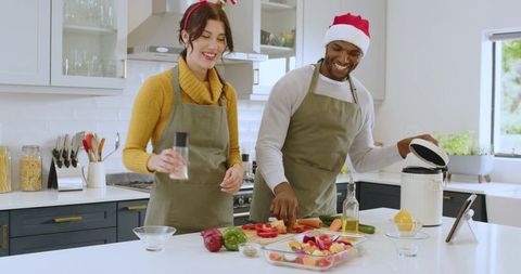 Festive Couple Preparing Meal Together in Modern Kitchen