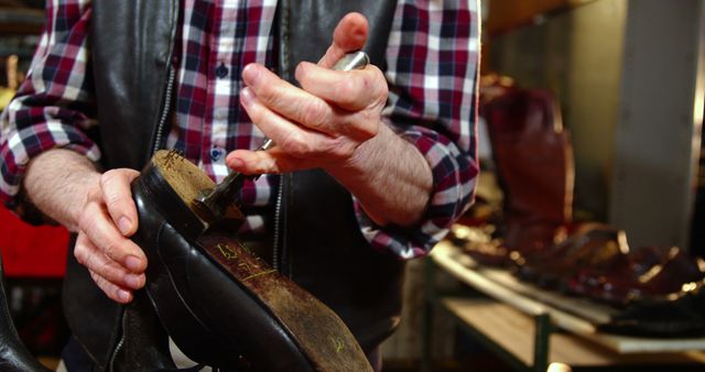Cobbler repairing shoes in workshop, highlighting craftsmanship and skill in restoring footwear. Suitable for use in articles about traditional trades, artisanship, manual skills, or advertisements for shoe repair services.