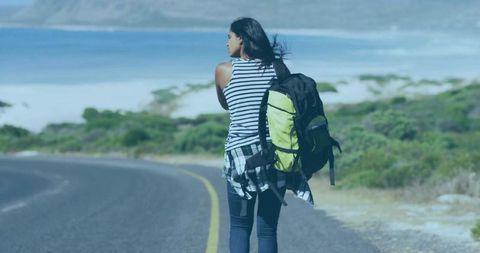 Solo Traveler Walking Along Scenic Beach Road