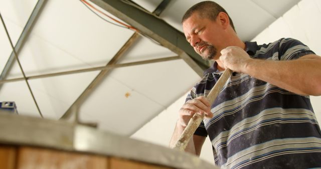 Man Stirring Ingredients in Industrial Kitchen - Download Free Stock Images Pikwizard.com