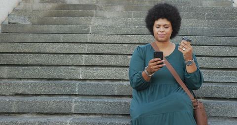 Happy Woman Drinking Coffee and Using Smartphone on Steps