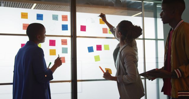 Team Brainstorming New Ideas with Sticky Notes in Modern Office - Download Free Stock Images Pikwizard.com