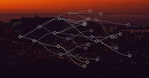 Tracing network overlay across coastal city skyline at dusk with nodes and light trails