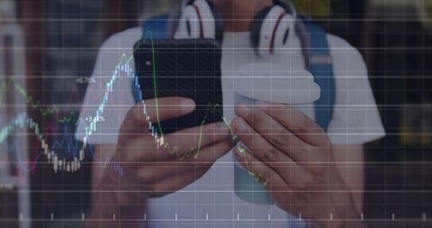 Commuter checking smartphone while holding coffee cup with stock market chart overlay