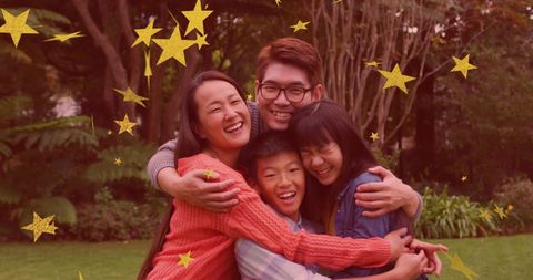 Asian Family Embracing in Garden with Gold Stars Overlay