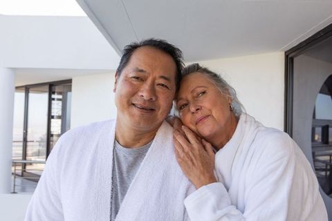 Senior Couple Embracing Leisurely Moment on Modern Balcony