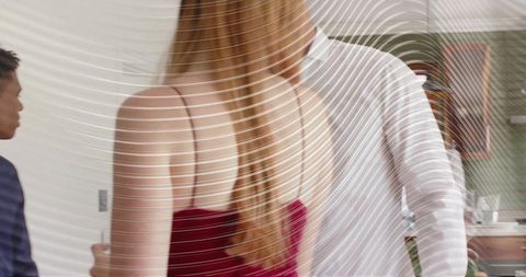 Blonde woman in burgundy dress standing in modern apartment with ripple distortion overlay