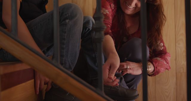 Woman Smiling While Helping Child Put On Shoes - Download Free Stock Images Pikwizard.com