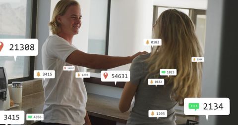 Happy Couple Dancing in Kitchen with Social Media Notifications