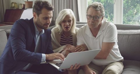 Young Man Assisting Senior Couple with Laptop Technology - Download Free Stock Images Pikwizard.com