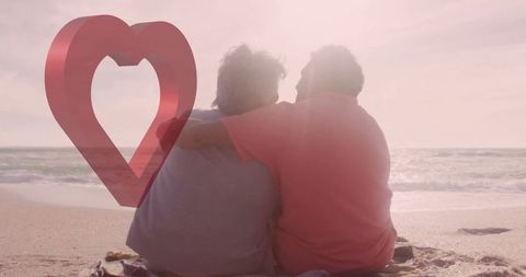 Senior Couple Enjoying Romantic Beach Sunset with Heart Overlay