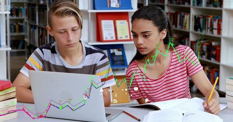 School Students Analyzing Data with Laptop in Library