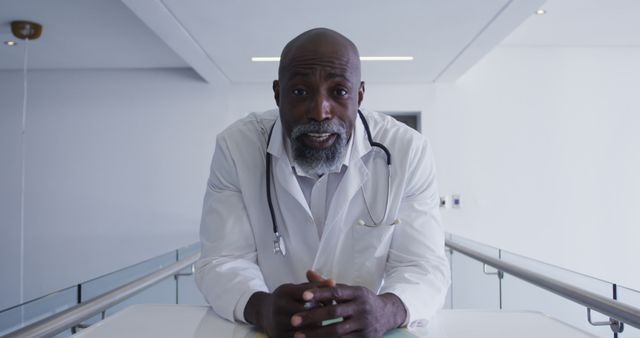 Portrait of african american male senior doctor talking looking at the camera at hospital. distant communication and telemedicine consultation concept.