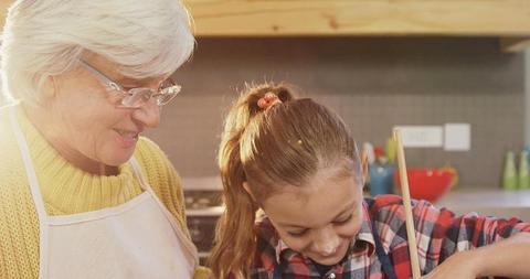 Grandmother and Granddaughter Enjoying Cooking Together - Download Free Stock Images Pikwizard.com