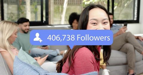 Smiling young woman with 406,738 followers overlay on couch with friends using smartphones
