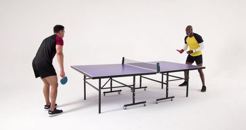 Diverse Friends Competing in Table Tennis Match