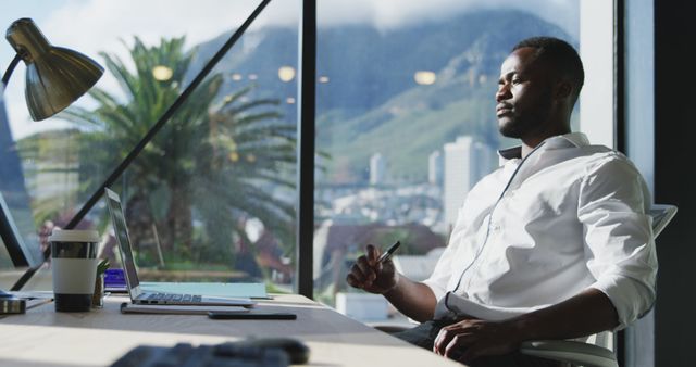 Businessman working in modern office with mountain view - Download Free Stock Images Pikwizard.com