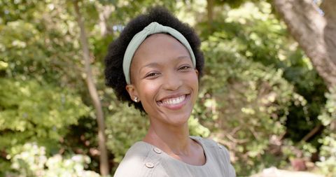 Joyful Woman Smiling in Lush Garden
