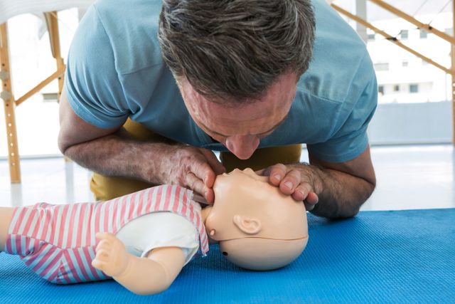 Paramedic Practicing Infant CPR on Training Dummy - Download Free Stock Photos Pikwizard.com