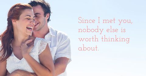 Joyful couple embracing against clear blue sky
