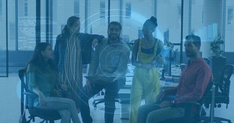 Coworkers using technology in modern office for team collaboration