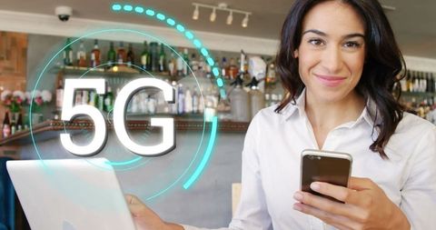 Businesswoman Embracing 5G Technology in Modern Workspace