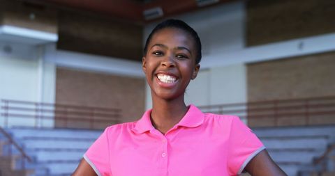 Confident Female Volleyball Player Smiling in Indoor Court
