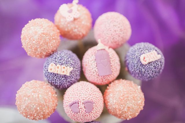 Bright and colorful baby shower cake pops with pastel decorations and baby-themed toppers. Ideal for use in party invitations, dessert table displays, celebration planning, and social media posts celebrating baby showers.