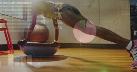 Female athlete performing bosu plank wearing sports bra and shorts with data overlay