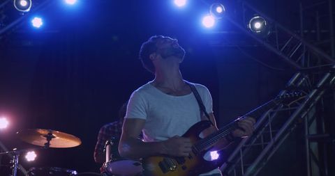 Guitarist Jamming Live on Stage in Dynamic Lighting - Download Free Stock Images Pikwizard.com