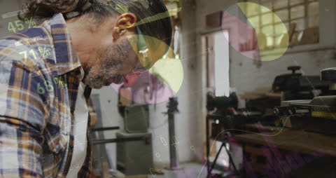 Man Analyzing Data with Statistics Overlay in Workshop Environment