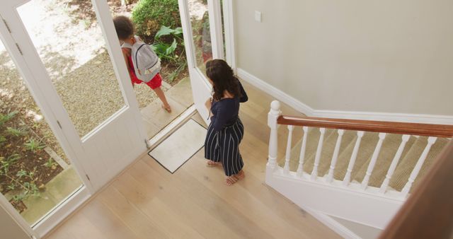 Bird's Eye View of Two Children Coming Home, Leaving and Entering - Download Free Stock Images Pikwizard.com