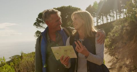 Senior Couple Embracing on a Hike in Sunny Countryside