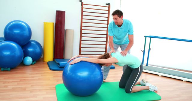 Physical Therapist Assisting Woman with Exercise Ball in Gym - Download Free Stock Images Pikwizard.com