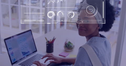 Businesswoman Analyzing Graphs on Laptop with Digital Data Overlay