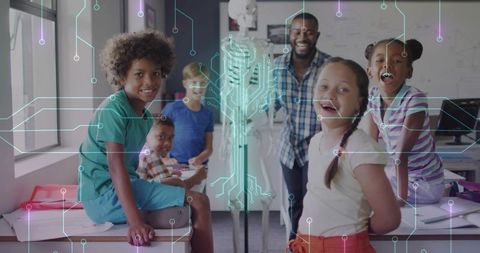 Teacher guiding diverse students in hands-on STEM lab with skeleton and circuit graphics