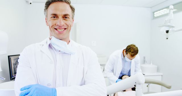 Confident Dentist in Clinic with Team Treating Patient - Download Free Stock Images Pikwizard.com