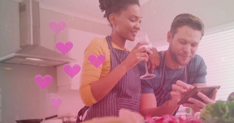 Diverse Couple Cooking Together in Modern Kitchen with Tablet