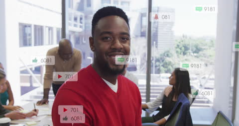 Smiling Professional Engaging in Social Media Interaction in Office