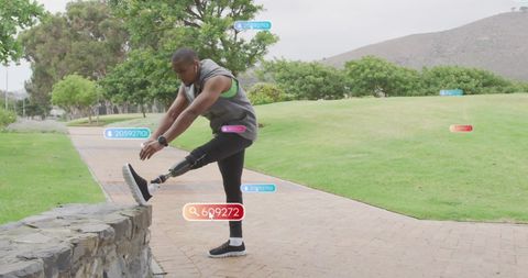 Amputee Man Stretching in Park with Social Media Notifications - Download Free Stock Images Pikwizard.com