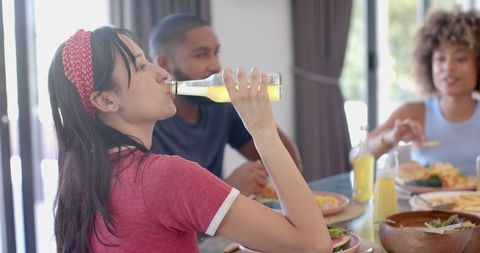 Diverse group of friends socializing over meal at home