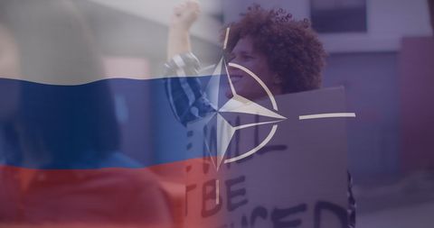 Protester with russia and nato symbols highlighting conflict