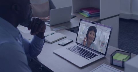 Executive watching Asian woman customer support on laptop during remote office meeting
