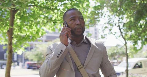 Confident Businessman Communicating on Smartphone in Urban Park