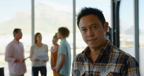 Confident Asian Business Executive in Modern Office Environment