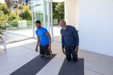 Father and Son Performing Yoga on Outdoor Patio