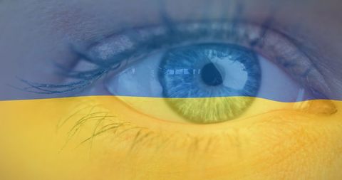 Closeup of eye with ukrainian flag reflection